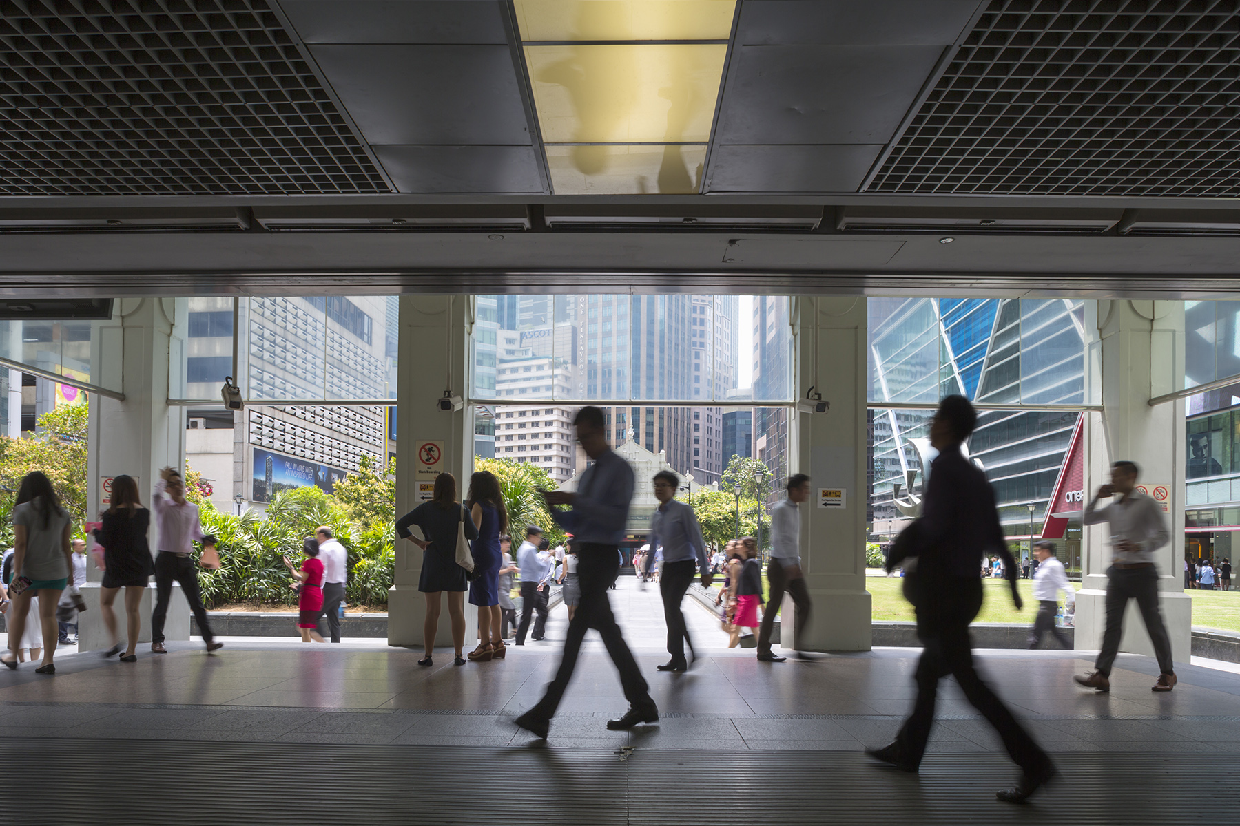 Workers walking around , Raffles Place MRT station, Singapore's financial district.

