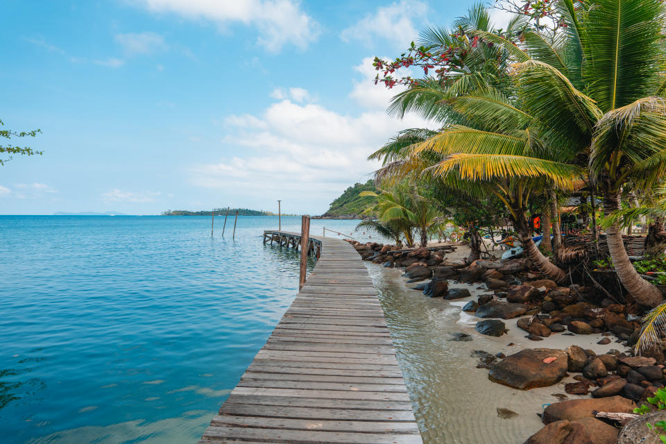 Wooden bridge into the sea on a tropical island