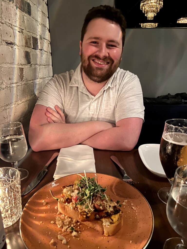 Where to Eat in Yaletown, Vancouver 20 Colin in front of a toast appetizer at Brix & Mortar, Yaletown, Vancouver