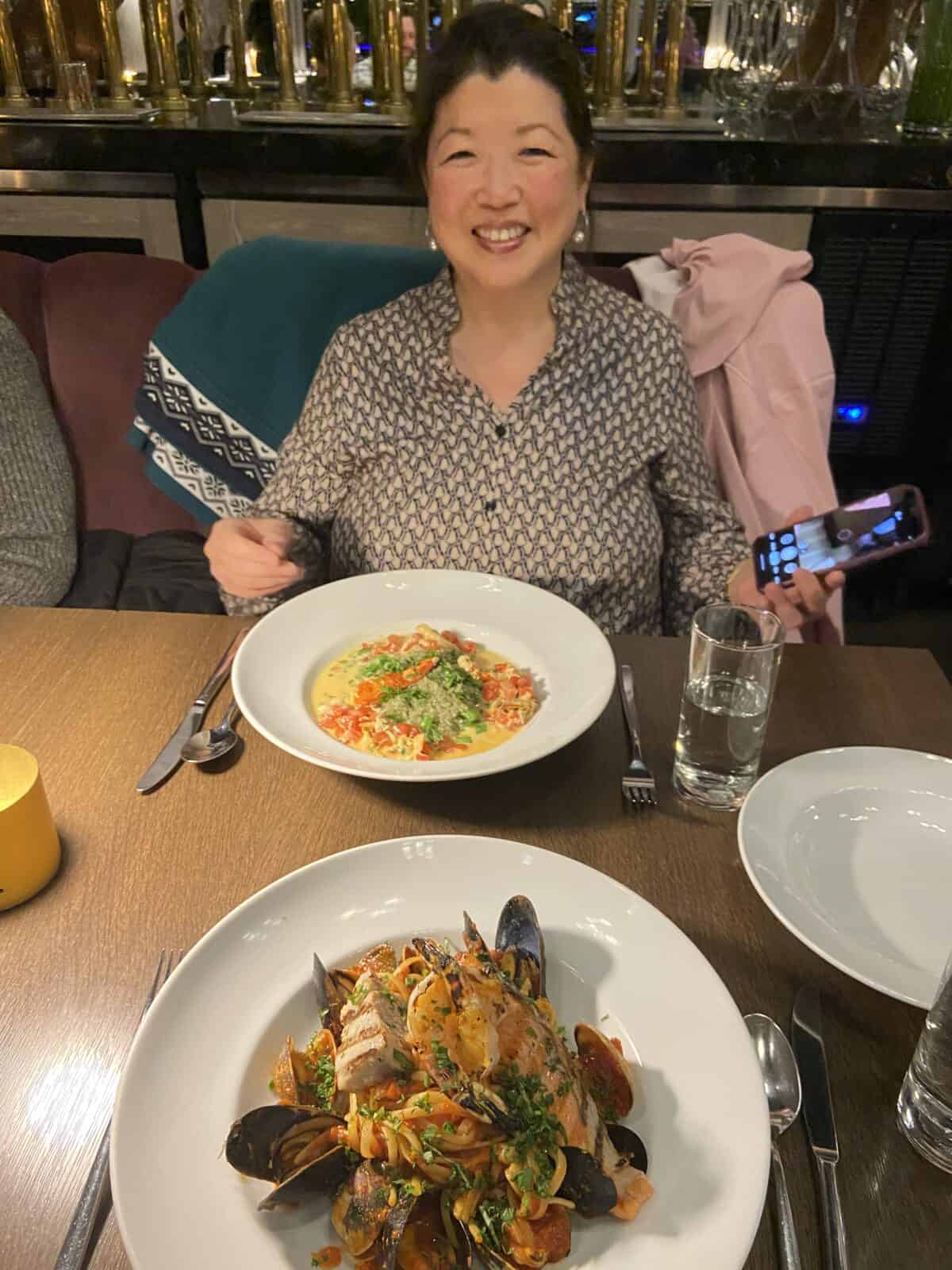 Where to Eat in Yaletown, Vancouver 33 Kathryn in front of two seafood dishes from Provence Marinaside