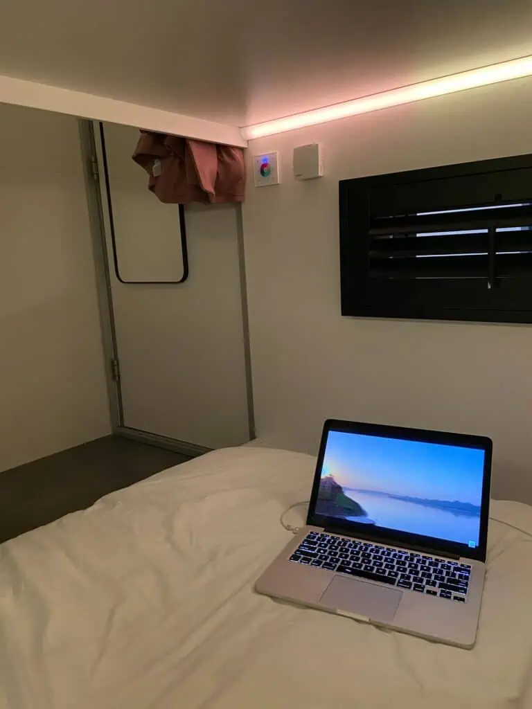 The lower bed with a laptop open on it at THIS HO(S)TEL cube hotel in Amsterdam