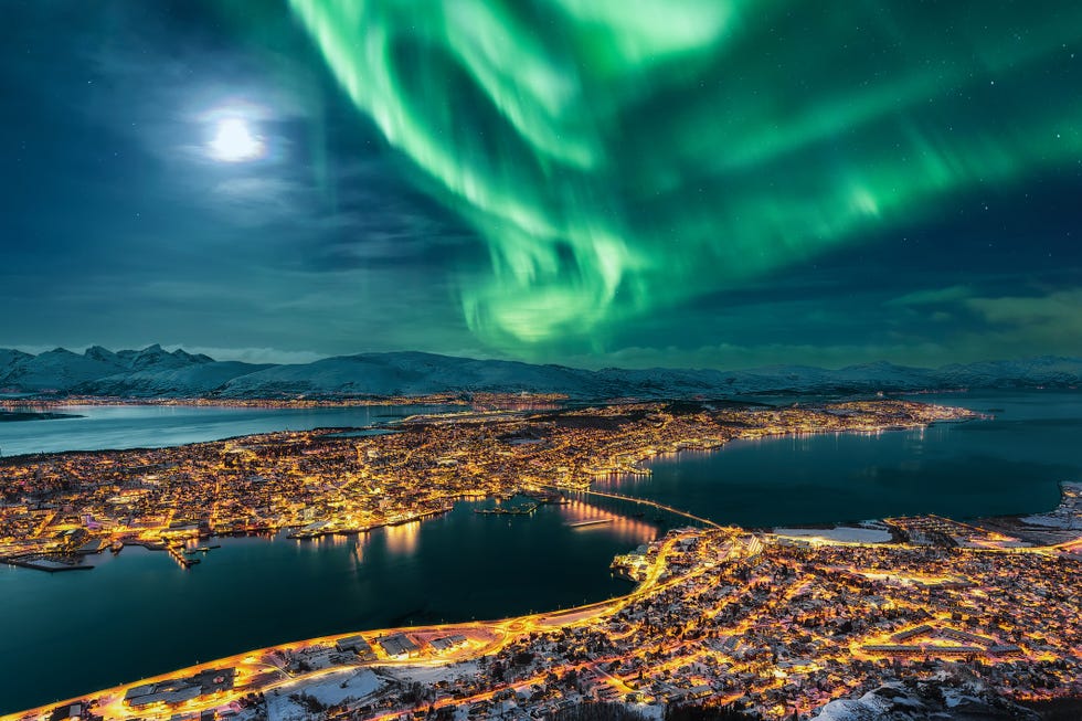 aurora borealis dancing over the city of tromso